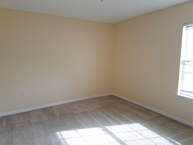 carpeted empty room featuring a healthy amount of sunlight