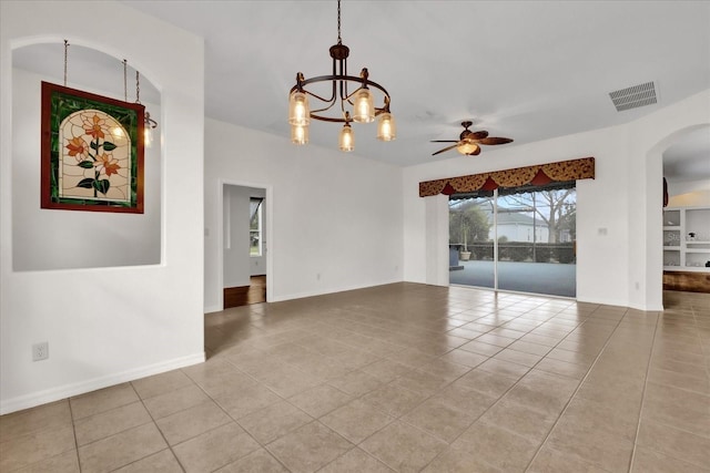 spare room featuring light tile patterned floors and ceiling fan with notable chandelier