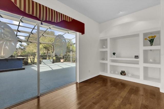 doorway featuring hardwood / wood-style floors and built in features