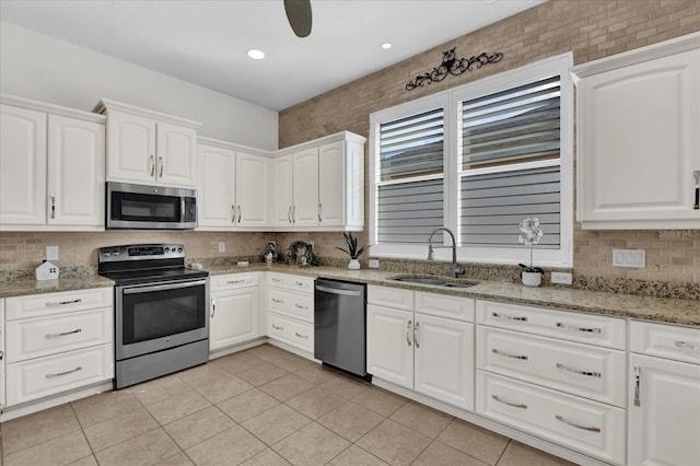 kitchen featuring white cabinetry, sink, stainless steel appliances, and light stone countertops