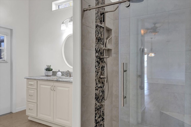 bathroom featuring vanity, tile patterned floors, and a shower with door