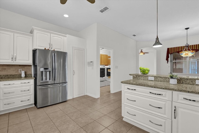 kitchen with stone counters, pendant lighting, white cabinetry, backsplash, and stainless steel fridge with ice dispenser