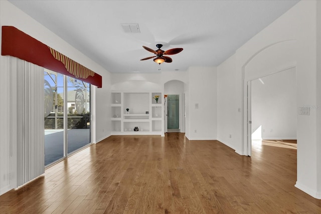 unfurnished living room with hardwood / wood-style flooring, ceiling fan, and built in features