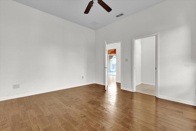 empty room featuring ceiling fan and hardwood / wood-style floors