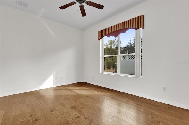 spare room featuring hardwood / wood-style floors and ceiling fan