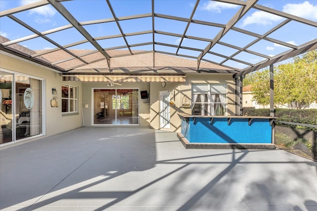 view of swimming pool with a patio and glass enclosure