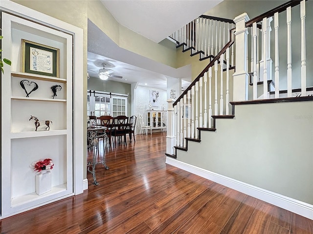 interior space with built in features, hardwood / wood-style floors, and ceiling fan