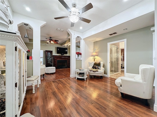 sitting room featuring ceiling fan and dark hardwood / wood-style flooring