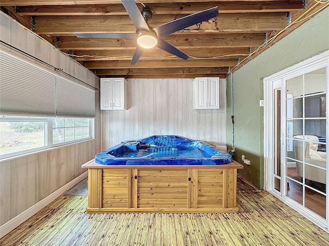 wooden terrace featuring ceiling fan and a jacuzzi