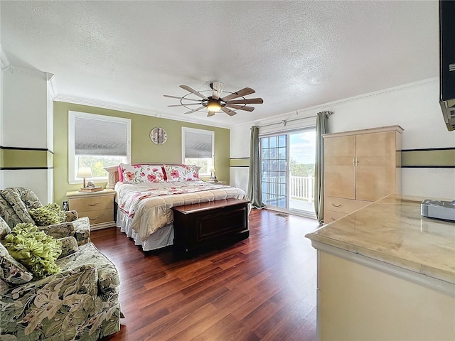 bedroom featuring dark hardwood / wood-style flooring, access to outside, crown molding, and a textured ceiling