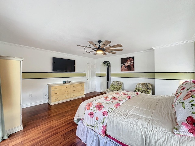 bedroom with dark wood-type flooring, crown molding, and ceiling fan