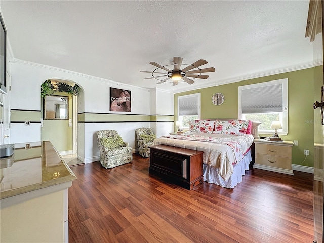 bedroom with dark hardwood / wood-style flooring, crown molding, and a textured ceiling