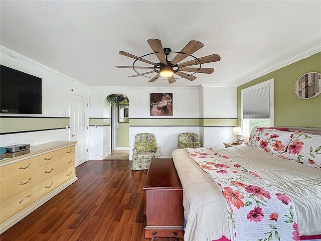 bedroom featuring ceiling fan, crown molding, dark hardwood / wood-style floors, and a textured ceiling