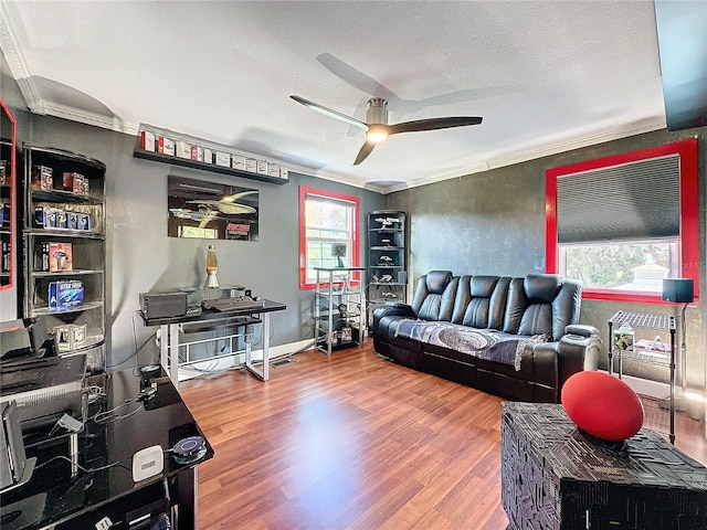 living room with hardwood / wood-style flooring, ornamental molding, a textured ceiling, and ceiling fan