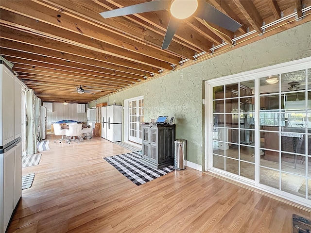 interior space with ceiling fan