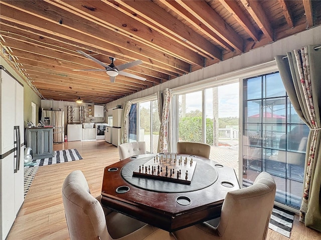 dining space featuring ceiling fan, light hardwood / wood-style flooring, beam ceiling, and wood ceiling