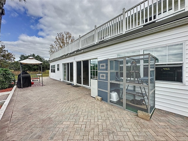 view of patio featuring a balcony and a gazebo