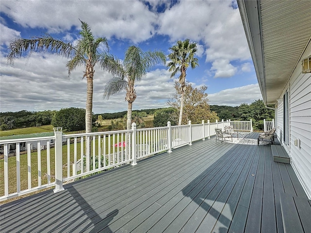 wooden terrace with a lawn