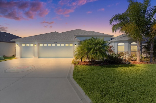 view of front of property with a lawn and a garage