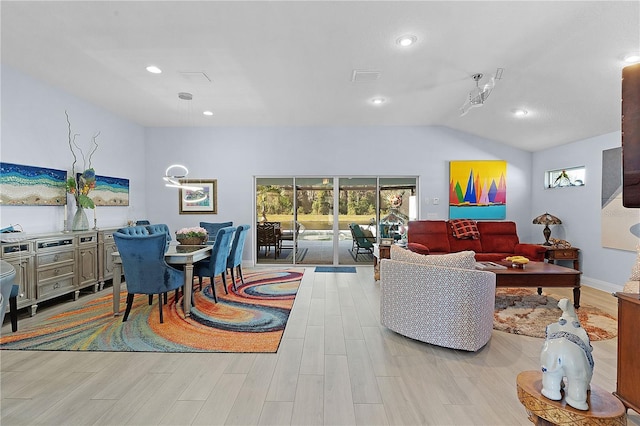 living room with light hardwood / wood-style flooring and lofted ceiling