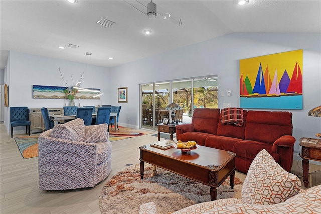 living room with light wood-type flooring, vaulted ceiling, and ceiling fan