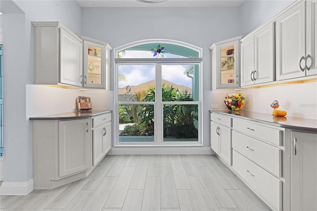 kitchen featuring white cabinets, light hardwood / wood-style flooring, and a wealth of natural light