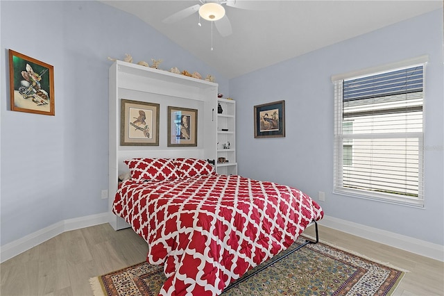 bedroom featuring hardwood / wood-style flooring, ceiling fan, and lofted ceiling