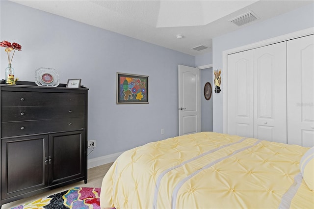 bedroom featuring light hardwood / wood-style flooring and a closet