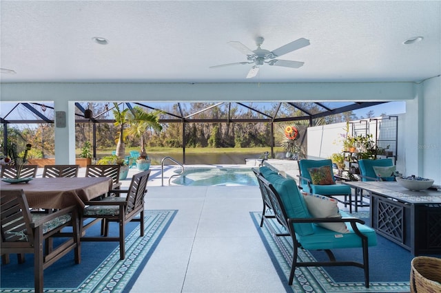 view of swimming pool featuring a patio, ceiling fan, and a lanai