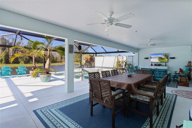 view of patio featuring glass enclosure and ceiling fan