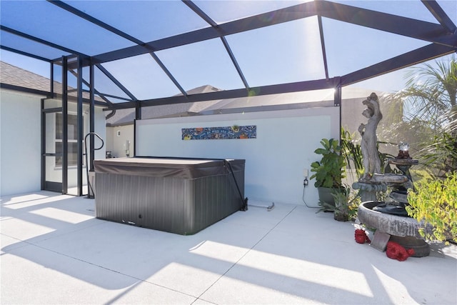 view of patio featuring a hot tub and a lanai