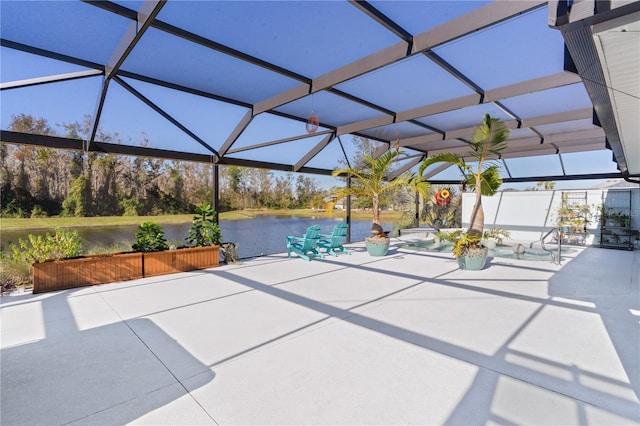 view of patio featuring a water view and a lanai