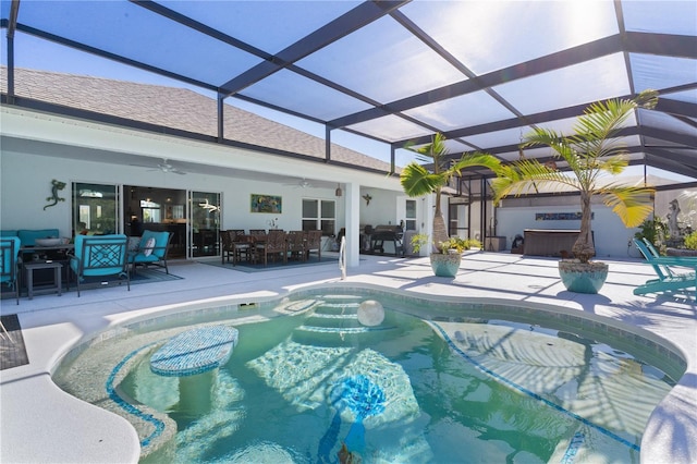 view of swimming pool with a patio, glass enclosure, and ceiling fan