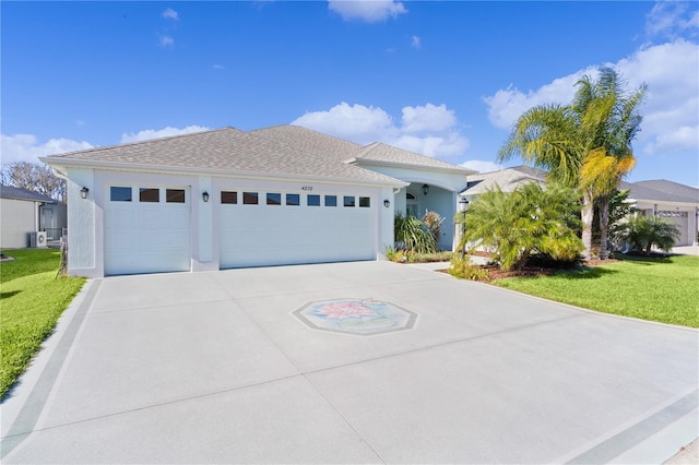 view of front of home with a garage and a front lawn