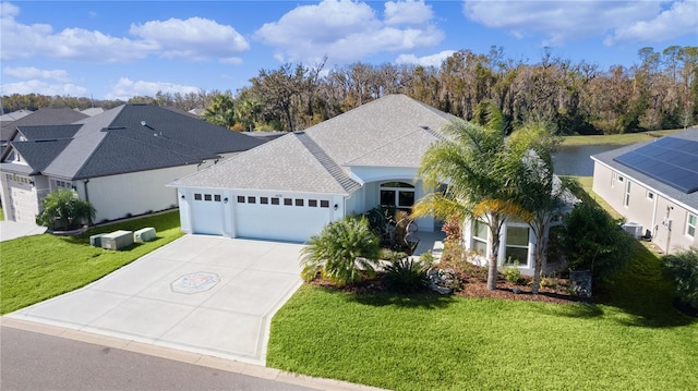 ranch-style house with a water view, a garage, central air condition unit, and a front yard