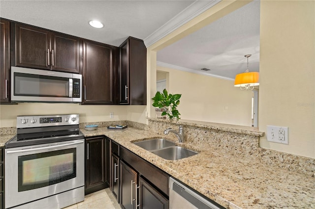 kitchen featuring light stone countertops, sink, hanging light fixtures, stainless steel appliances, and ornamental molding