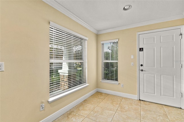 foyer featuring light tile patterned floors, a textured ceiling, and crown molding