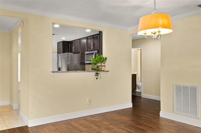 kitchen featuring dark hardwood / wood-style flooring, kitchen peninsula, and appliances with stainless steel finishes