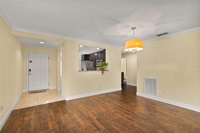 interior space with crown molding and hardwood / wood-style floors