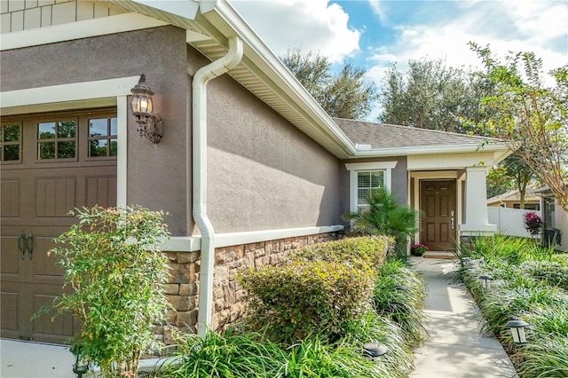 doorway to property with a garage