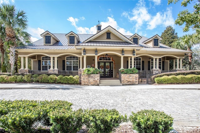 view of front of home featuring covered porch and french doors