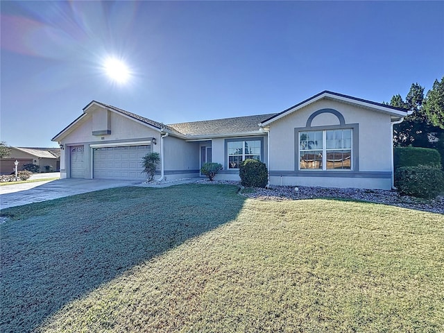 single story home with a front yard, driveway, an attached garage, and stucco siding