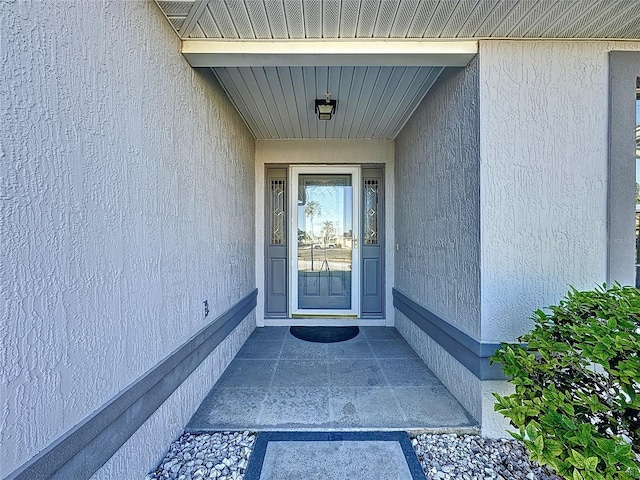 property entrance featuring stucco siding