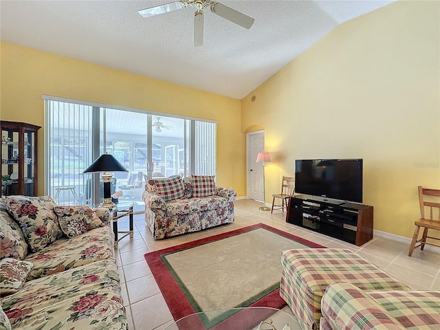 tiled living room featuring a textured ceiling, ceiling fan, and lofted ceiling