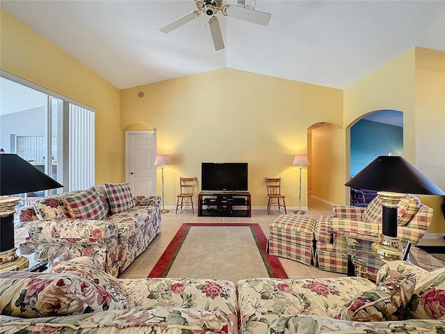 living room with light tile patterned floors, a textured ceiling, vaulted ceiling, and ceiling fan