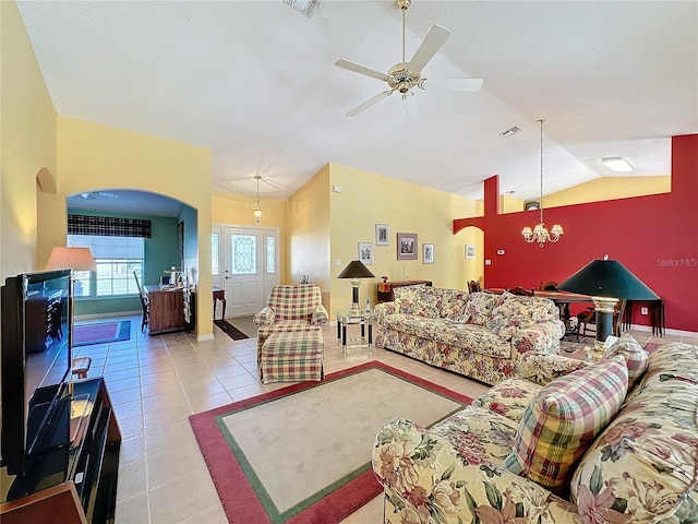 tiled living room with ceiling fan with notable chandelier, lofted ceiling, and a textured ceiling