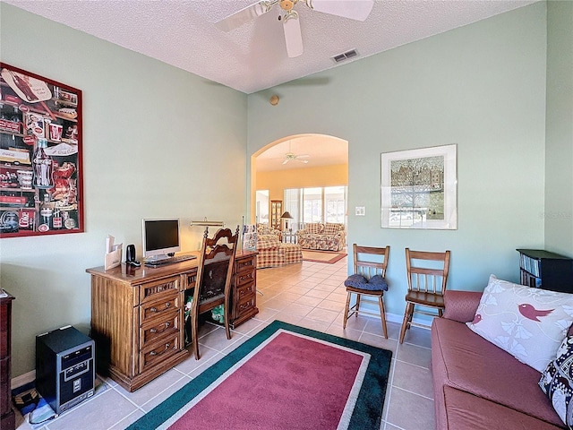 home office with ceiling fan, light tile patterned floors, and a textured ceiling