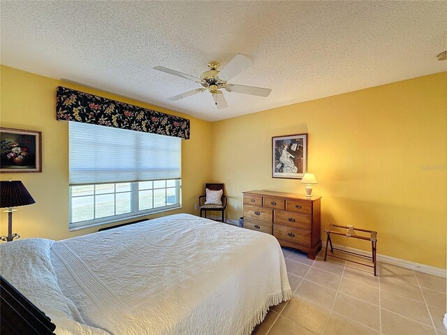 4634 Summerbridge Cir, Leesburg, FL 34748 - bedroom with light tile patterned flooring, a textured ceiling, baseboards, and ceiling fan