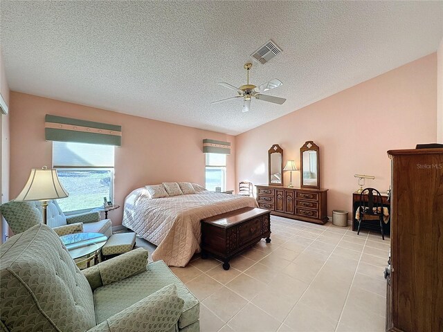 4634 Summerbridge Cir, Leesburg, FL 34748 - bedroom with light tile patterned flooring, a textured ceiling, and a ceiling fan