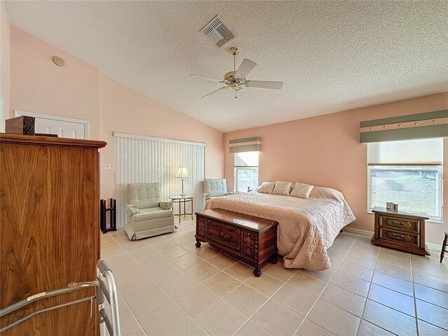 4634 Summerbridge Cir, Leesburg, FL 34748 - bedroom with light tile patterned floors, lofted ceiling, a textured ceiling, and ceiling fan